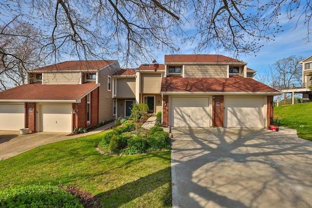traditional home with concrete driveway, brick siding, and a front yard