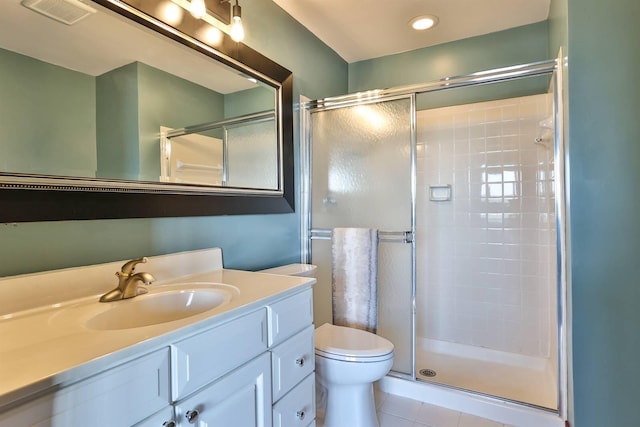 full bathroom featuring visible vents, toilet, a stall shower, and vanity