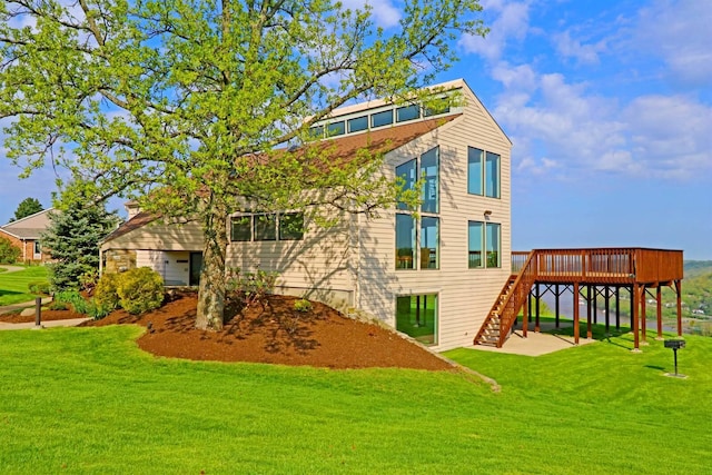 back of property featuring a lawn, a wooden deck, stairway, and a patio area