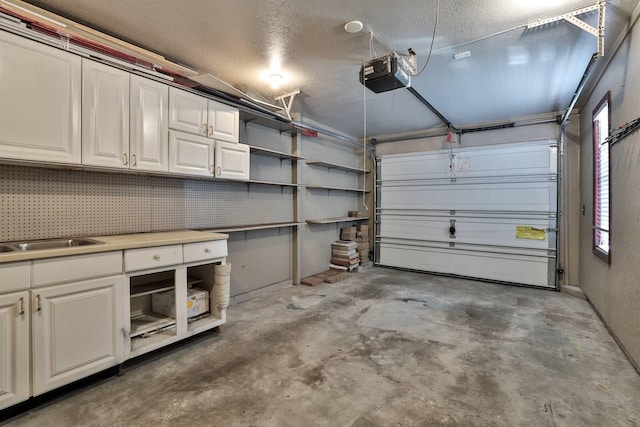 garage featuring a sink and a garage door opener