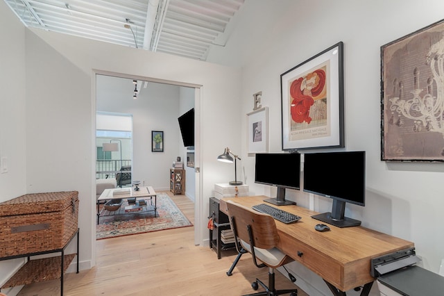 office featuring light wood-style flooring and baseboards