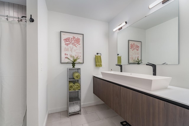 bathroom with tile patterned floors, a shower with shower curtain, vanity, and baseboards