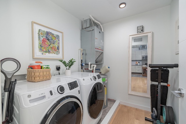 laundry area featuring laundry area, light wood-style floors, visible vents, and washer and clothes dryer