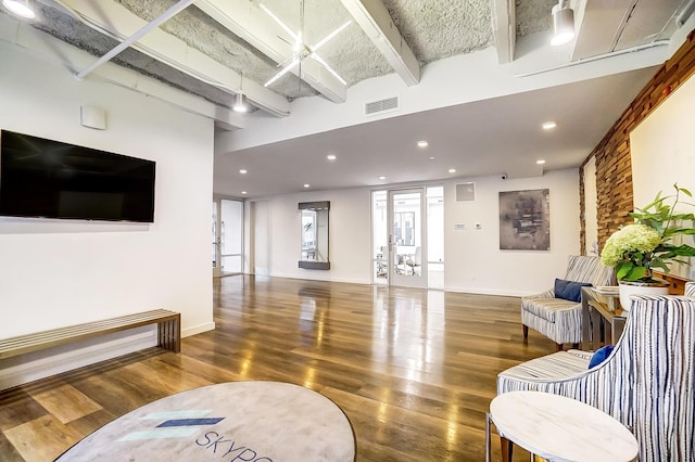interior space featuring beamed ceiling, visible vents, recessed lighting, wood finished floors, and baseboards