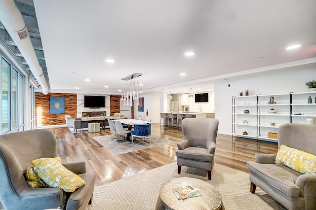 living room with light wood-type flooring and recessed lighting