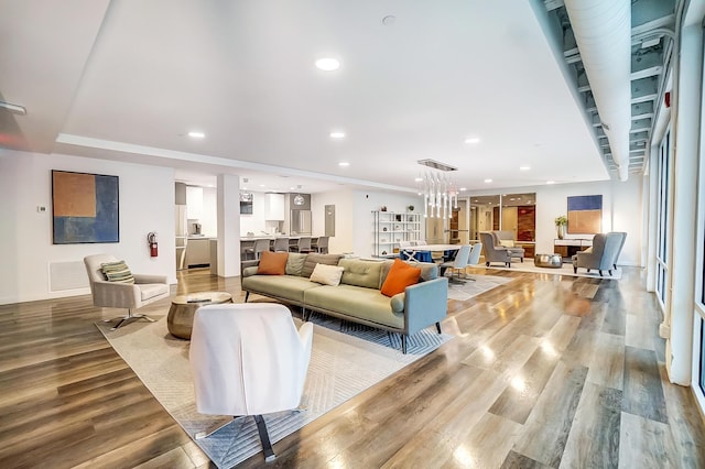 living room featuring wood finished floors, visible vents, and recessed lighting