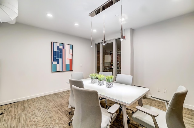 dining room with baseboards and recessed lighting