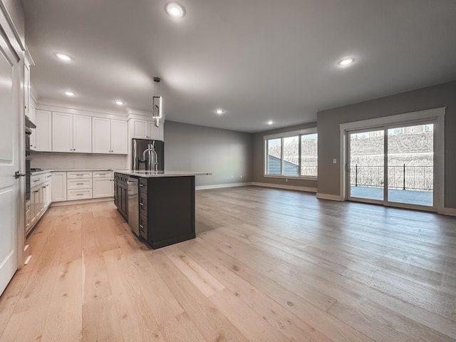 739 Manhattan Blvd Unit 103, Dayton, KY 41074 - kitchen featuring white cabinets, baseboards, light countertops, light wood-style floors, and recessed lighting