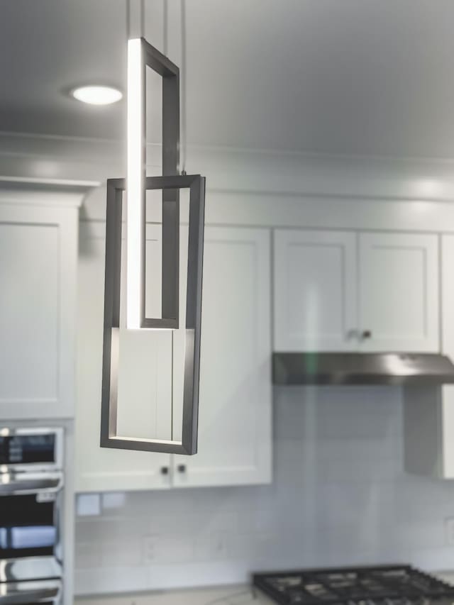 739 Manhattan Blvd Unit 103, Dayton, KY 41074 - room details featuring under cabinet range hood, white cabinetry, and oven