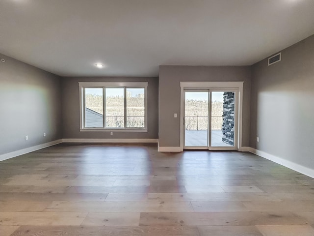 739 Manhattan Blvd Unit 103, Dayton, KY 41074 - empty room with a wealth of natural light, visible vents, and wood finished floors