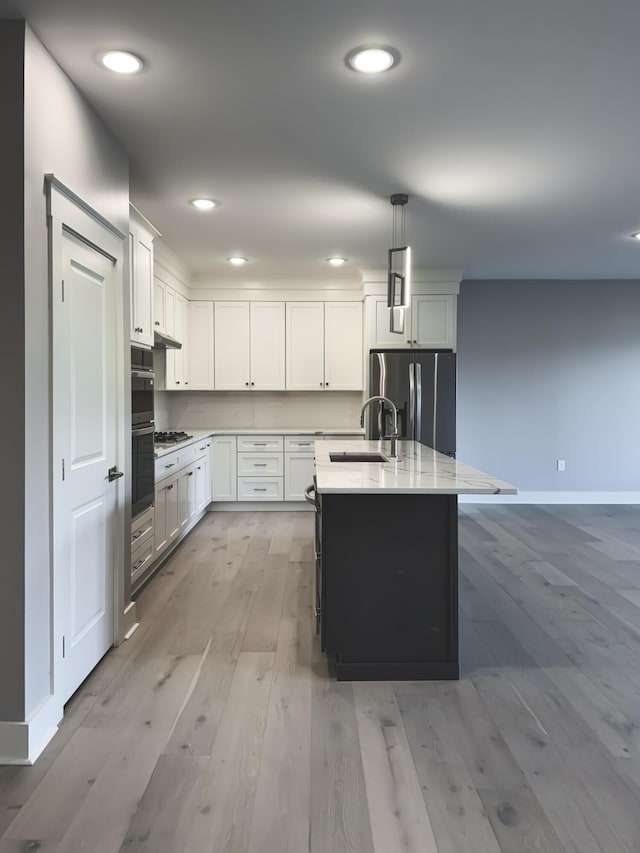 739 Manhattan Blvd Unit 103, Dayton, KY 41074 - kitchen featuring stainless steel fridge, light wood-style flooring, white cabinets, gas stovetop, and a sink