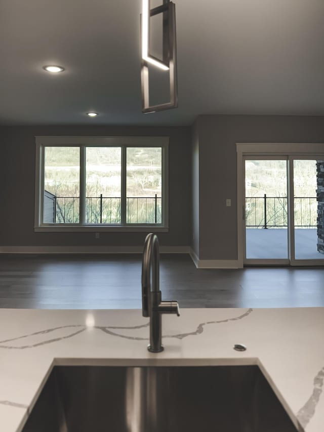739 Manhattan Blvd Unit 103, Dayton, KY 41074 - details with baseboards, a sink, recessed lighting, wood finished floors, and light stone counters