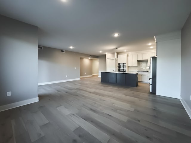 739 Manhattan Blvd Unit 103, Dayton, KY 41074 - kitchen featuring freestanding refrigerator, white cabinetry, recessed lighting, open floor plan, and baseboards