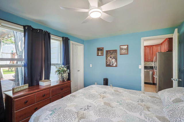 bedroom featuring freestanding refrigerator, a ceiling fan, and light tile patterned floors