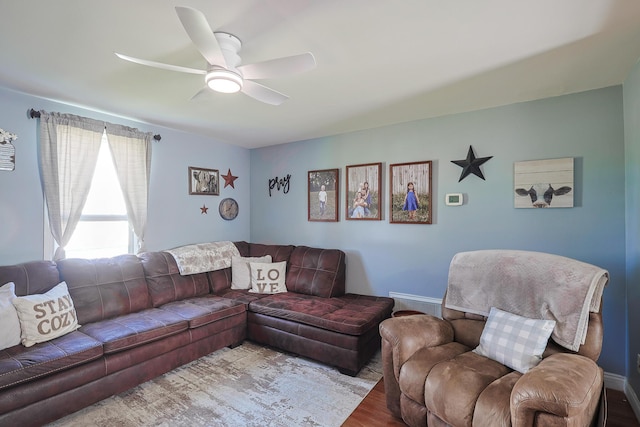 living room with a ceiling fan and wood finished floors