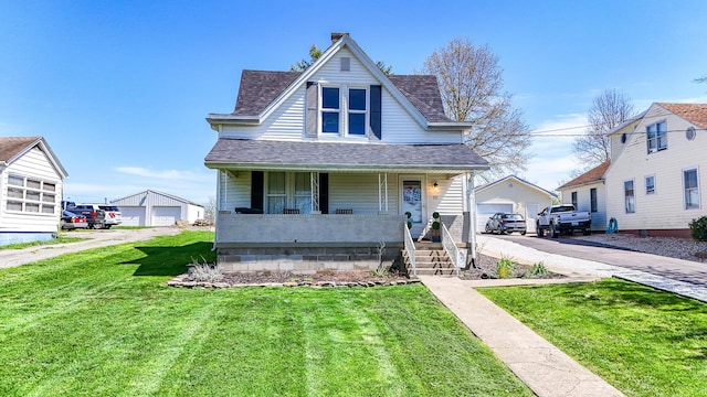 view of front facade featuring a front yard, an outbuilding, covered porch, and roof with shingles