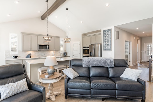 living area with light wood-style flooring, recessed lighting, and a chandelier