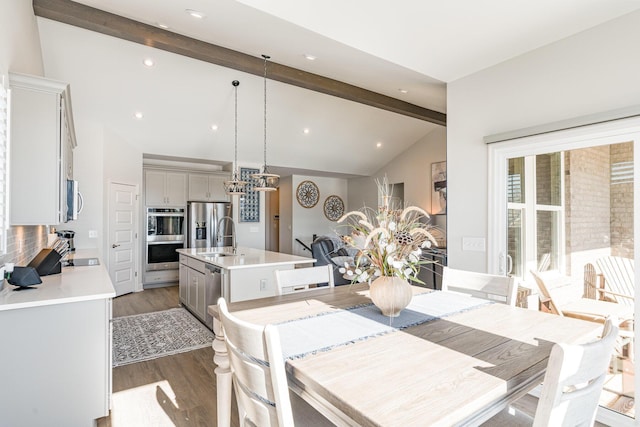 dining room with a chandelier, wood finished floors, and recessed lighting