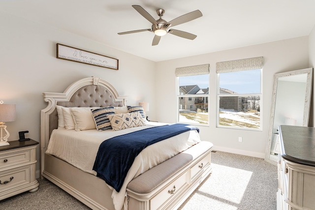 bedroom with light colored carpet, baseboards, and ceiling fan