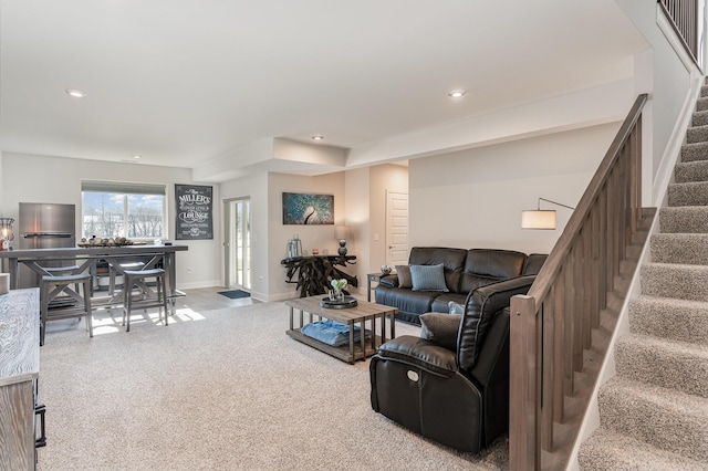 carpeted living room with stairway, baseboards, and recessed lighting