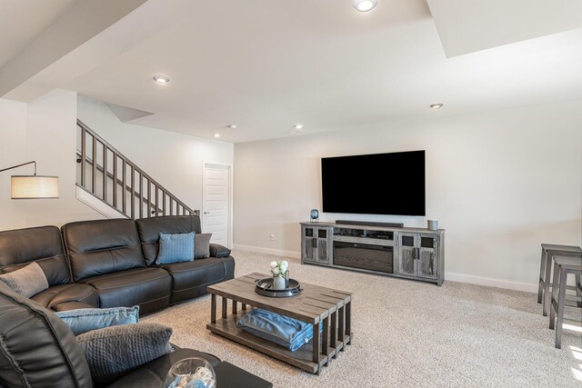 carpeted living room with stairway, baseboards, and recessed lighting