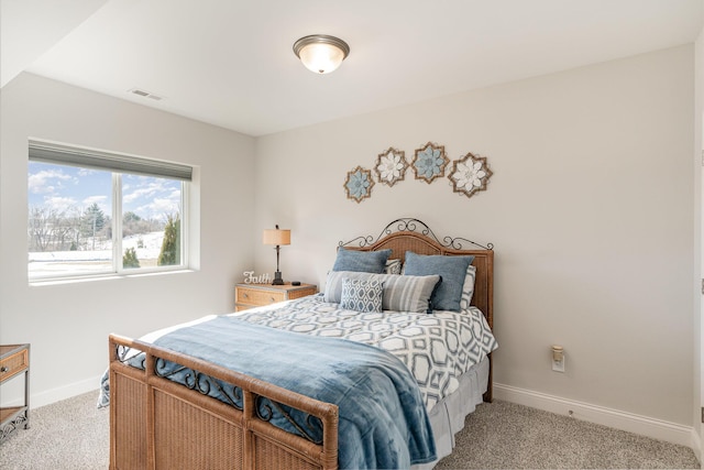 bedroom featuring light colored carpet and baseboards