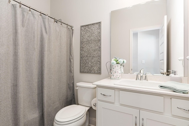 bathroom featuring toilet and vanity