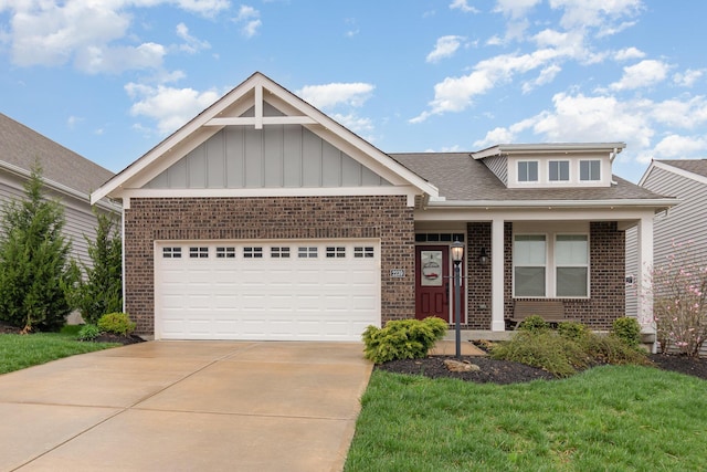 view of front of home featuring driveway, brick siding, a garage, and board and batten siding