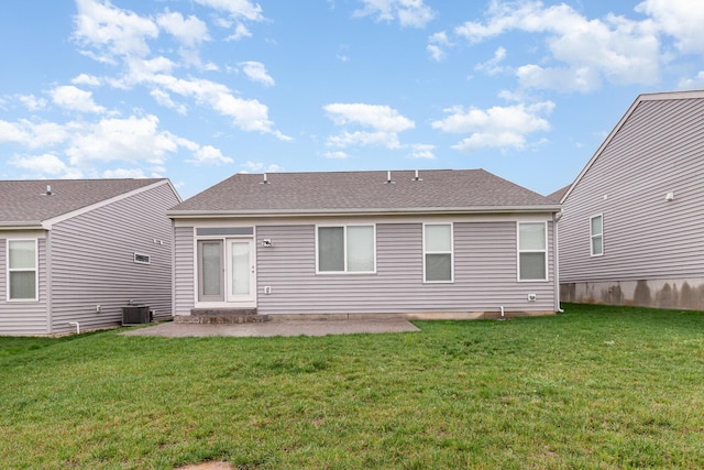 back of house with a patio, a shingled roof, central air condition unit, and a lawn