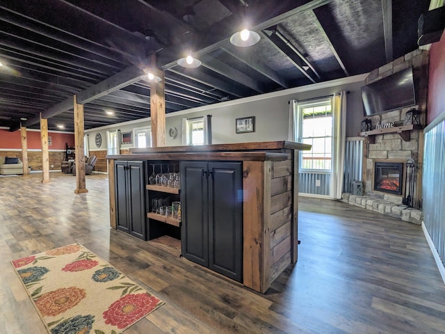4400 Chipman Ridge Rd, Williamstown, KY 41097 - below grade area with a dry bar, a stone fireplace, healthy amount of natural light, and dark wood-style flooring