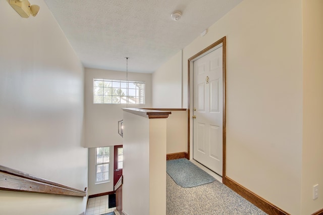 7370 Centrecrest Ln Unit E, Florence, KY 41042 - corridor featuring plenty of natural light, a textured ceiling, baseboards, and a chandelier