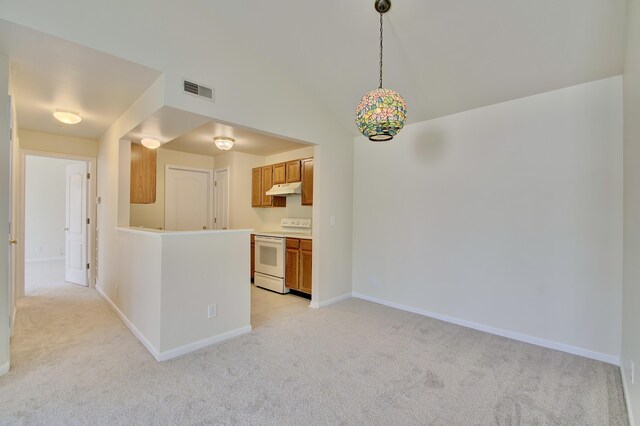 7370 Centrecrest Ln Unit E, Florence, KY 41042 - kitchen with electric stove, under cabinet range hood, light colored carpet, brown cabinets, and baseboards