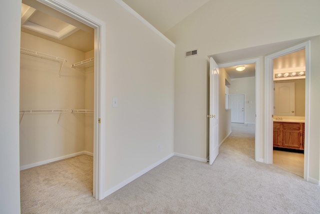 7370 Centrecrest Ln Unit E, Florence, KY 41042 - unfurnished bedroom with light carpet, a closet, a walk in closet, and baseboards