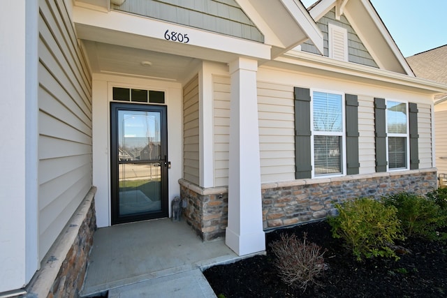 view of exterior entry with stone siding