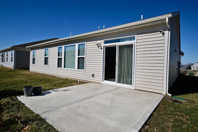 back of property with a patio area and a lawn