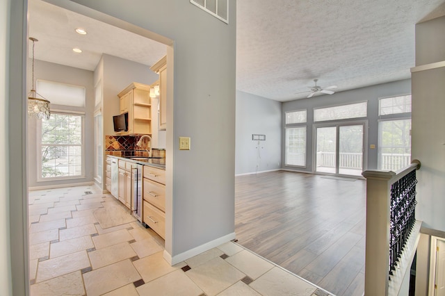 2141 Tantallon Dr, Fort Mitchell, KY 41017 - hall with a healthy amount of sunlight, baseboards, a sink, and visible vents