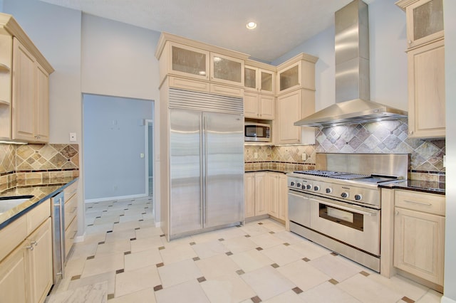 2141 Tantallon Dr, Fort Mitchell, KY 41017 - kitchen featuring wall chimney range hood, tasteful backsplash, baseboards, glass insert cabinets, and built in appliances