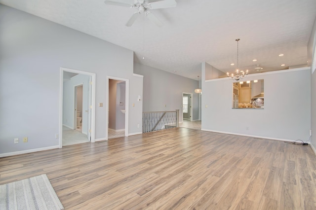 2141 Tantallon Dr, Fort Mitchell, KY 41017 - unfurnished living room with recessed lighting, baseboards, light wood finished floors, and ceiling fan with notable chandelier