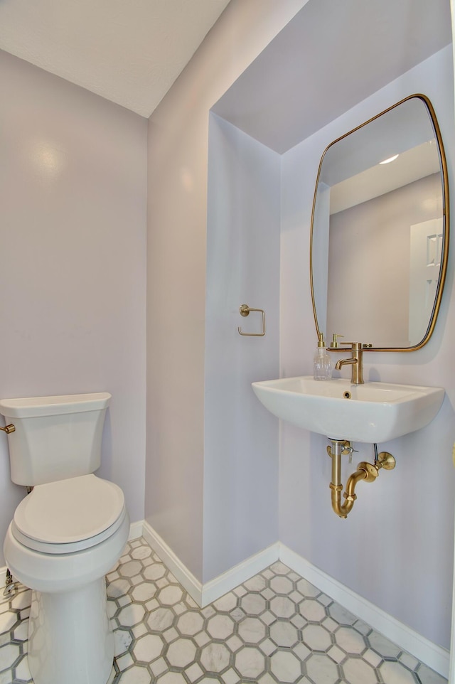2141 Tantallon Dr, Fort Mitchell, KY 41017 - half bathroom with baseboards, a sink, tile patterned floors, and toilet