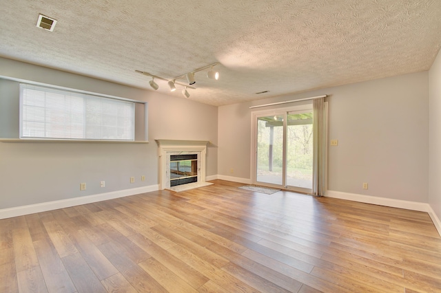 2141 Tantallon Dr, Fort Mitchell, KY 41017 - unfurnished living room with light wood-type flooring, baseboards, track lighting, and a fireplace