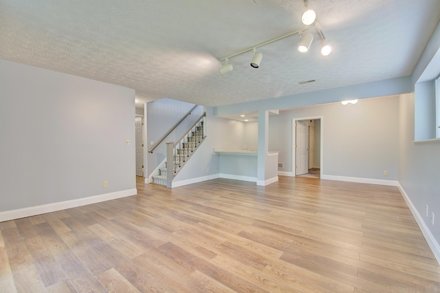 2141 Tantallon Dr, Fort Mitchell, KY 41017 - basement with light wood-type flooring, baseboards, track lighting, and stairway