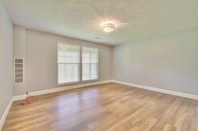2141 Tantallon Dr, Fort Mitchell, KY 41017 - unfurnished room featuring baseboards, a textured ceiling, and light wood finished floors