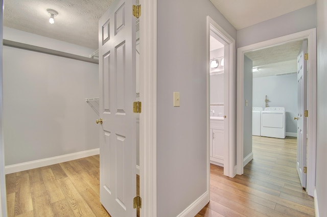 2141 Tantallon Dr, Fort Mitchell, KY 41017 - corridor with independent washer and dryer, baseboards, and light wood-style floors