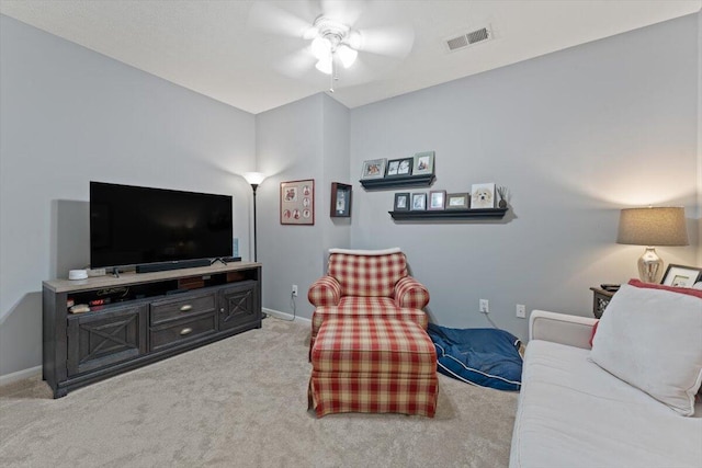 living room with baseboards, light carpet, a ceiling fan, and visible vents