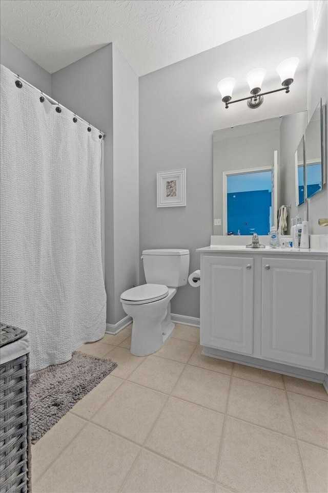 full bath with toilet, a shower with shower curtain, tile patterned flooring, and vanity
