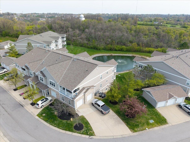drone / aerial view featuring a water view and a view of trees