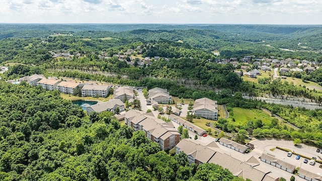 birds eye view of property featuring a residential view and a wooded view