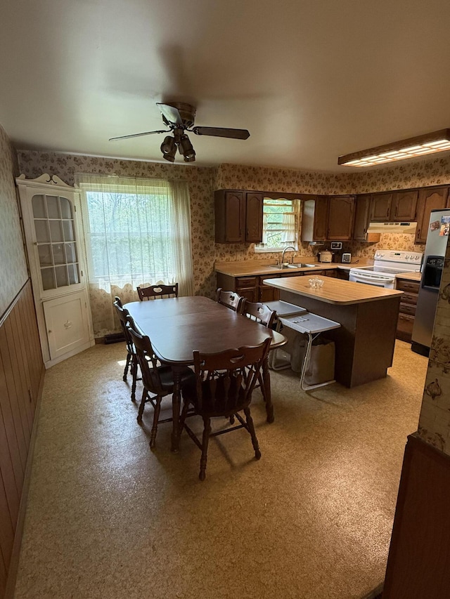 143 Capri Dr, Fort Thomas, KY 41075 - dining space featuring wallpapered walls, ceiling fan, and wainscoting