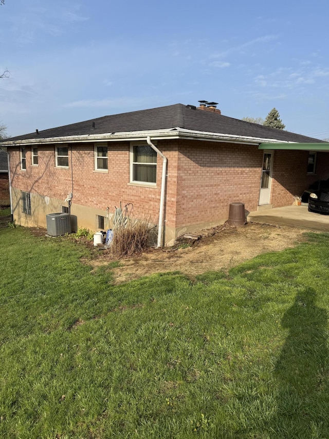 143 Capri Dr, Fort Thomas, KY 41075 - view of home's exterior featuring brick siding, a yard, and central air condition unit