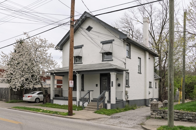 1706 Eastern Ave, Covington, KY 41014 - traditional style home featuring covered porch, a chimney, and brick siding